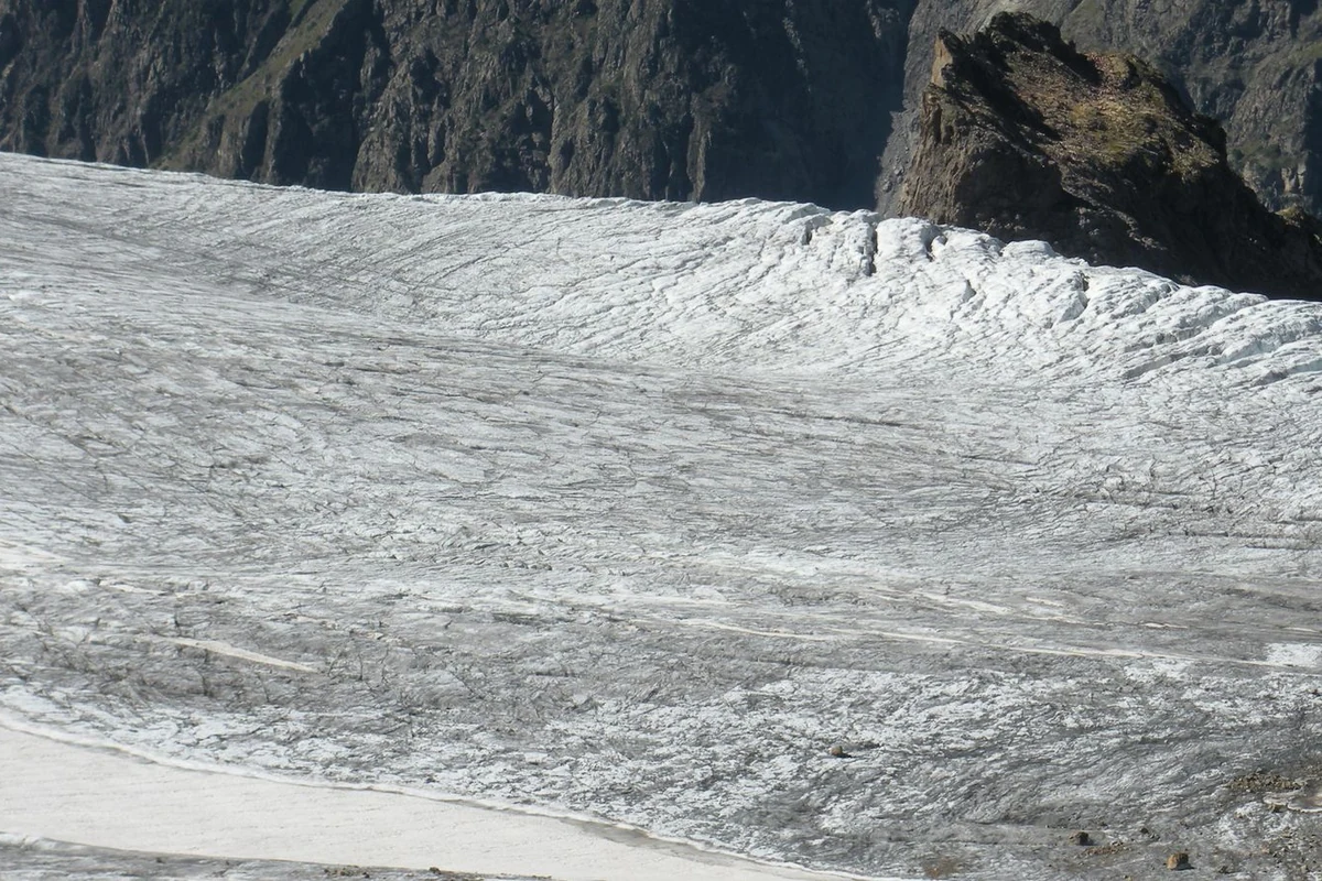 Chalaadi Glacier with snow-covered rugged mountain peaks above