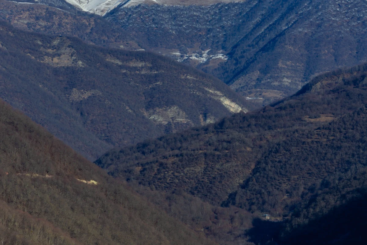 Snow-capped Caucasus mountain peaks rising above the Georgian highlands — the dramatic high-altitude terrain trekkers encounter on the Black Rock Lake trail in Lagodekhi National Park