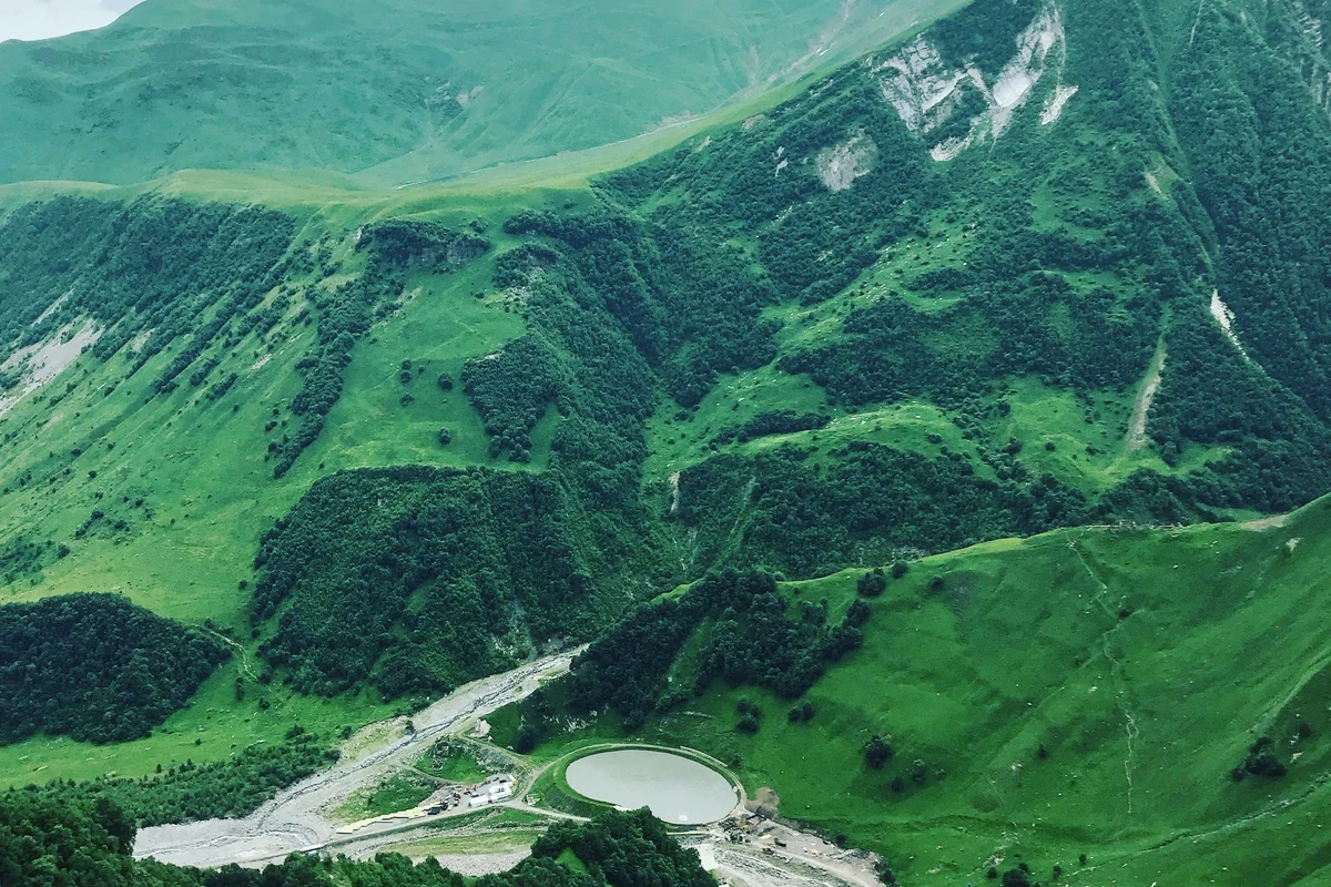 Panoramic view of lush mountain landscapes in the Mtskheta-Mtianeti region of Georgia — the best trekking season for Tusheti and Khevsureti runs from late June through September